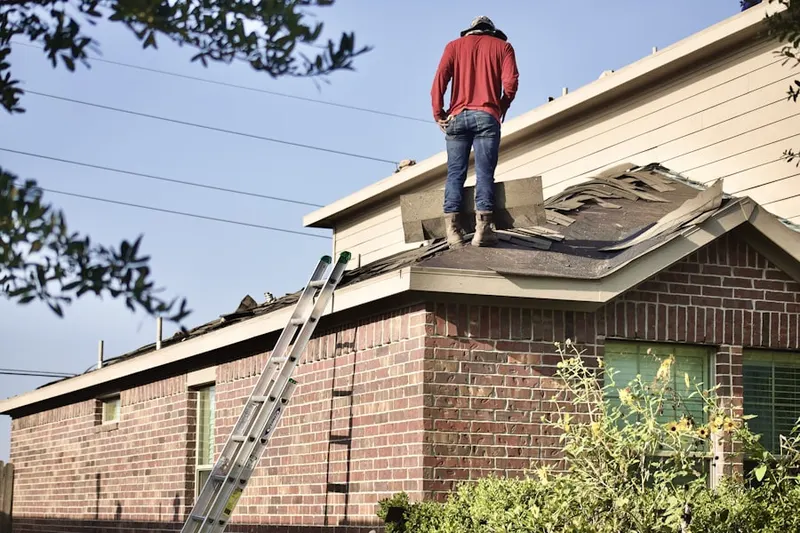 Professional roofer working on a residential roof in Horse Landing